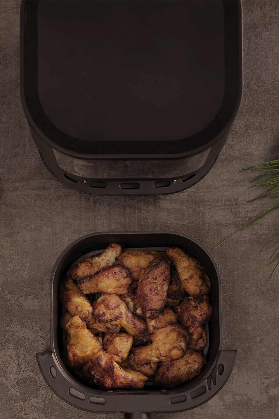Braun air fryer filled with seasoned chicken and various fresh ingredients, ready for a healthy cooking experience.